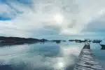 people walking on wooden dock under white clouds and blue sky during daytime